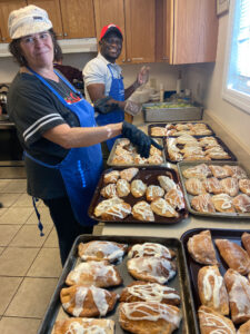 Picture: Man and Woman getting pastry desserts ready to serve for a Gathering Grace Meal